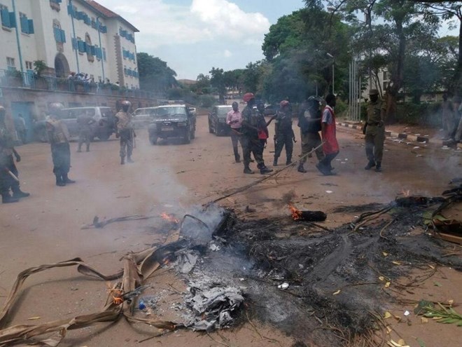 Uganda police put off bonfires lit on a road by Makerere students. /COURTESY